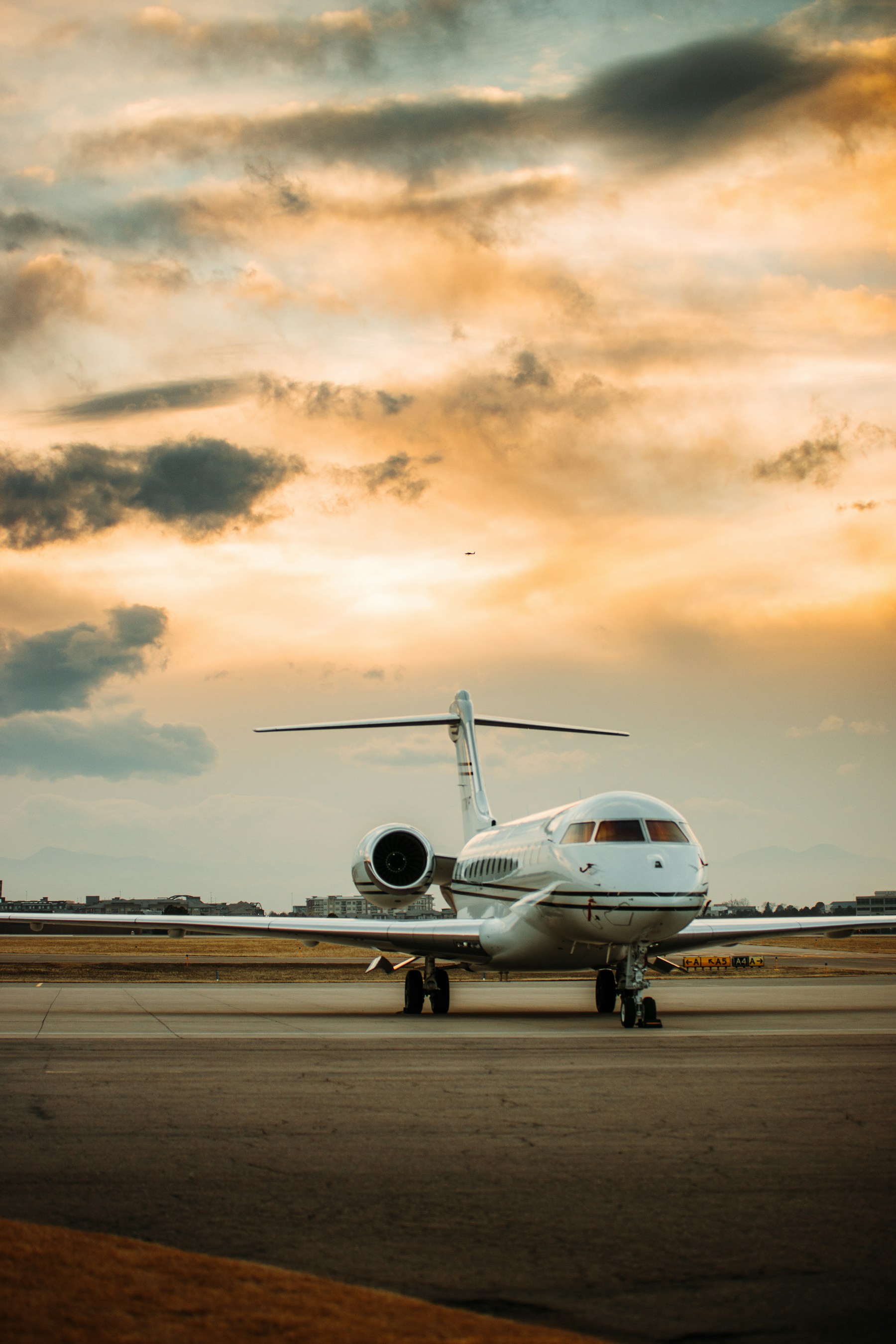 Private jet on the tarmac under a dramatic sky